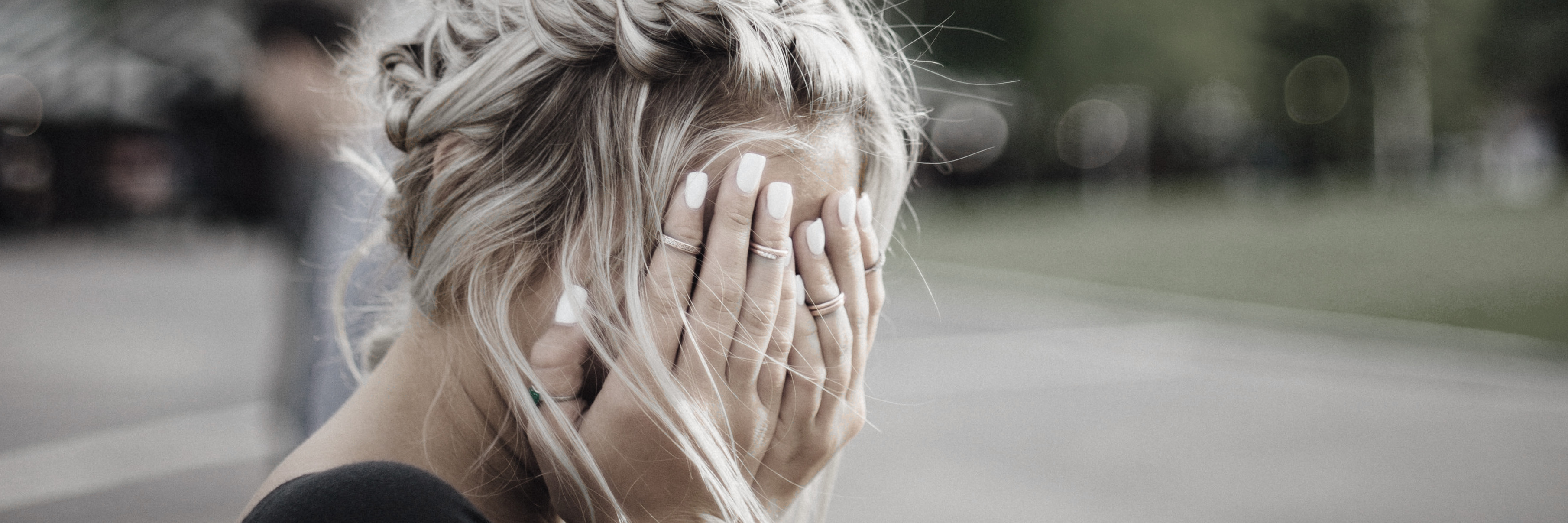 photo of a woman hiding her face with her hands